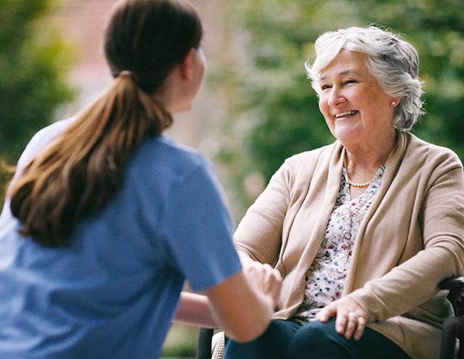 Guaranteed Acceptance Life - young female nurse helping older lady outside
